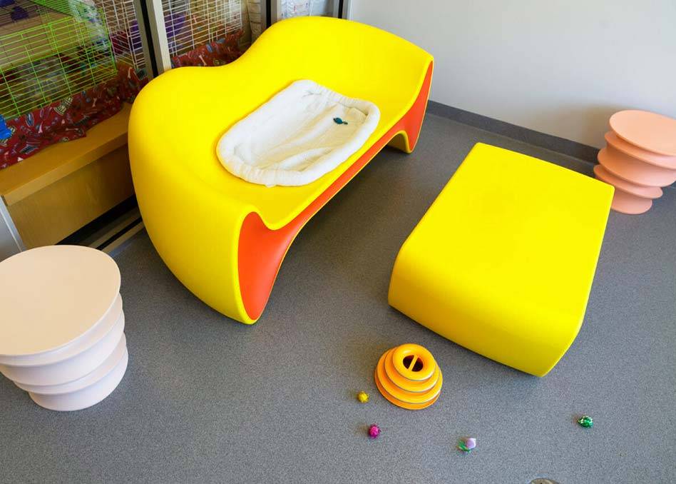 a yellow and orange baby furniture on concrete coated floor